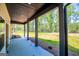 Covered patio with views of lush greenery and wooded surroundings at 90 Ayers Rd, Bowdon, GA 30108