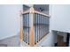 Staircase features wooden railing with decorative black iron spindles and carpeted steps to an open area at 90 Ayers Rd, Bowdon, GA 30108
