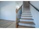 Stairway with hardwood treads and decorative wood and metal railing at 90 Ayers Rd, Bowdon, GA 30108