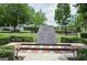 City of Woodstock 9/11 memorial featuring a stone monument and commemorative text surrounded by greenery at 147 Hubbard Rd, Woodstock, GA 30188
