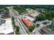 Aerial view showing the city's landscape, featuring train tracks, a market, and roads with cars and lush trees at 147 Hubbard Rd, Woodstock, GA 30188