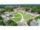 Aerial view showcasing the city's amphitheater, with well-maintained green spaces and a charming outdoor stage for community events at 147 Hubbard Rd, Woodstock, GA 30188