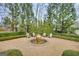 Tranquil backyard with fountain, gravel, surrounded by hedges, shrubbery and mature trees at 147 Hubbard Rd, Woodstock, GA 30188