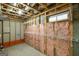 Unfinished basement space with exposed insulation, wooden framing, and shelving at 147 Hubbard Rd, Woodstock, GA 30188