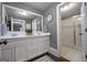 This bathroom features dual sinks with white cabinetry, a large mirror, and a separate shower at 147 Hubbard Rd, Woodstock, GA 30188