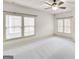 Expansive bedroom featuring a ceiling fan and ample natural light from the large windows at 147 Hubbard Rd, Woodstock, GA 30188