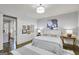 Bright bedroom with neutral color palette, wood floors, stylish rug, and decorative wall art at 147 Hubbard Rd, Woodstock, GA 30188