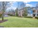 Beautiful townhomes with a manicured lawn, mature trees, and inviting curb appeal at 147 Hubbard Rd, Woodstock, GA 30188