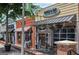 Charming storefront with a brick facade, featuring the 'Truck & Tap' restaurant and its inviting outdoor seating area at 147 Hubbard Rd, Woodstock, GA 30188