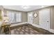Light-filled hallway with wood floors, decor, and entry door, radiating warmth at 147 Hubbard Rd, Woodstock, GA 30188