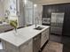 A well-lit kitchen featuring an island, stainless steel appliances, and pendant lighting at 147 Hubbard Rd, Woodstock, GA 30188