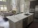 Open-concept kitchen features a large island, modern appliances, and seamless flow to living area at 147 Hubbard Rd, Woodstock, GA 30188