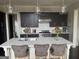Modern kitchen featuring stainless steel appliances, stylish lighting, and an eat-in island at 147 Hubbard Rd, Woodstock, GA 30188