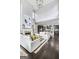 Bright living room with fireplace, open to the kitchen, and featuring hardwood floors and ample natural light at 147 Hubbard Rd, Woodstock, GA 30188