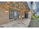 Cozy outdoor patio with stone flooring, string lights, and comfortable seating at 147 Hubbard Rd, Woodstock, GA 30188