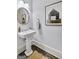 Clean powder room with white sink and stylish decor at 147 Hubbard Rd, Woodstock, GA 30188