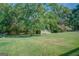 Large backyard with detached shed and lush trees at 463 Conyers Rd, Mcdonough, GA 30253