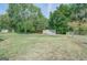 Large backyard with detached shed and chain link fence at 463 Conyers Rd, Mcdonough, GA 30253