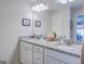 Double vanity bathroom with granite countertops and a large mirror at 463 Conyers Rd, Mcdonough, GA 30253