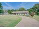 Ranch style home with mature landscaping and a long driveway at 463 Conyers Rd, Mcdonough, GA 30253
