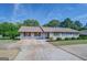 One-story home with carport and landscaped yard at 463 Conyers Rd, Mcdonough, GA 30253