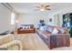 Spacious living room with leather couches and a ceiling fan at 463 Conyers Rd, Mcdonough, GA 30253