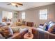 Open living room with leather sofas, a view into the dining area, and hardwood floors at 463 Conyers Rd, Mcdonough, GA 30253