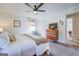 Main bedroom featuring a king bed, dresser, and ceiling fan at 463 Conyers Rd, Mcdonough, GA 30253