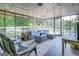 Spacious screened porch with comfortable seating at 463 Conyers Rd, Mcdonough, GA 30253