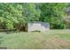 Detached shed in grassy backyard setting at 463 Conyers Rd, Mcdonough, GA 30253