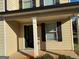 Front entrance with columns, door, and sidelights at 385 Mcgiboney Ln, Covington, GA 30016