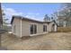 Back exterior view with a sliding glass door, windows, and a well-maintained backyard at 546 Paden Dr, Lawrenceville, GA 30044