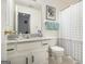 Bright bathroom features a modern vanity, new toilet, and an overhead light fixture at 546 Paden Dr, Lawrenceville, GA 30044