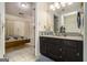 Cozy bathroom features a granite countertop, dark wood cabinets, and leads to the bedroom at 546 Paden Dr, Lawrenceville, GA 30044