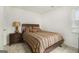 Relaxing bedroom featuring a side table with a lamp, a window, and neutral decor at 546 Paden Dr, Lawrenceville, GA 30044