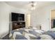 Spacious bedroom featuring a large TV, ceiling fan, and convenient access to an adjoining space at 546 Paden Dr, Lawrenceville, GA 30044