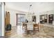Dining area with access to patio and living area, offering tile floors and modern light fixtures at 546 Paden Dr, Lawrenceville, GA 30044