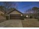 Front exterior view of a cozy home with a garage, landscaped yard, and inviting curb appeal at 546 Paden Dr, Lawrenceville, GA 30044