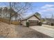 Angle view of the home's exterior, emphasizing the large garage and surrounding yard at 546 Paden Dr, Lawrenceville, GA 30044