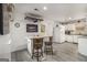 Eat-in kitchen with gray wood flooring, white cabinets, granite countertops, and stainless appliances at 546 Paden Dr, Lawrenceville, GA 30044