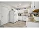 Spacious kitchen featuring white cabinets, granite countertops, and modern appliances at 546 Paden Dr, Lawrenceville, GA 30044