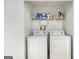 Laundry room with washer, dryer, and storage shelf at 546 Paden Dr, Lawrenceville, GA 30044