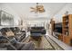 Open-concept living room featuring neutral tones, a ceiling fan, and seamless flow to the dining area at 546 Paden Dr, Lawrenceville, GA 30044