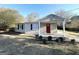 Charming brick ranch house featuring a covered porch and mature landscaping at 1876 Flat Shoals Se Rd, Atlanta, GA 30316