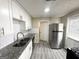 Modern kitchen with white shaker cabinets, granite countertops, and stainless steel appliances at 1876 Flat Shoals Se Rd, Atlanta, GA 30316
