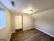 Finished basement room with vinyl flooring and a door leading outside at 3721 W Potomac Dr, East Point, GA 30344