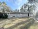 Ranch style home with gray brick exterior, sliding glass doors, and a patio at 3721 W Potomac Dr, East Point, GA 30344