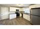 Modern kitchen featuring white cabinets and granite countertops at 3721 W Potomac Dr, East Point, GA 30344