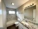 Updated bathroom with a granite vanity and marble shower surround at 2729 Pinella Sw Dr, Atlanta, GA 30331