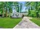 Ranch style home with a paved driveway and a well-maintained lawn at 2729 Pinella Sw Dr, Atlanta, GA 30331